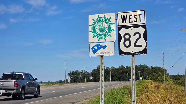 Two road signs of Great River Road Arkansas and West 82