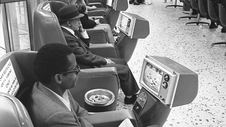 Passengers watching coin-operated TV's at 