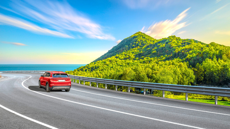 A car driving on a highway along the coast in Spain