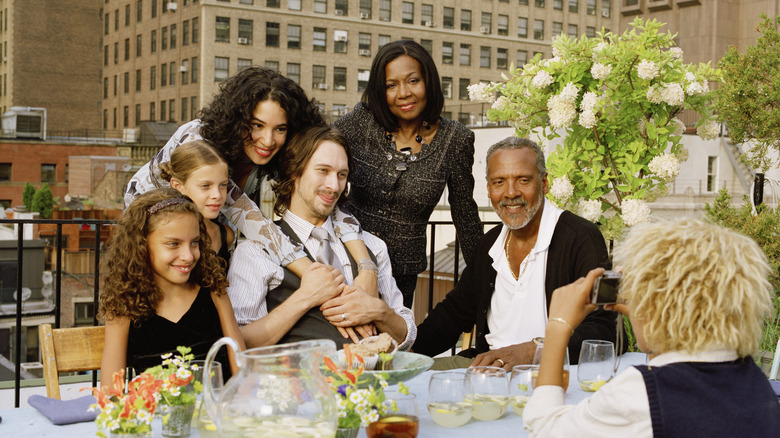 A family taking photos at a rooftop party in New York City