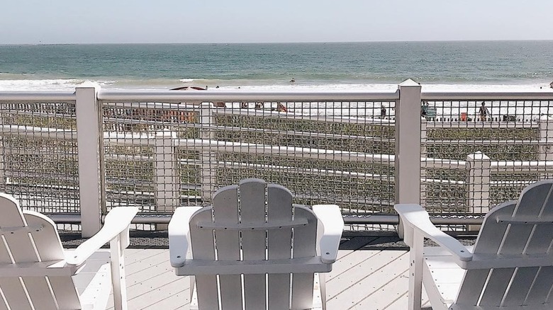 A row of wooden loungers face the beach at East Matunuck Beach