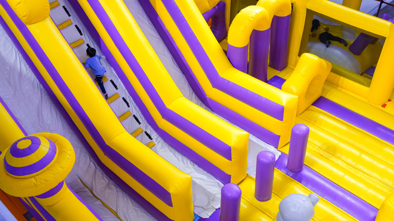 Image of child climbing the ladder on an inflatable jumping castle