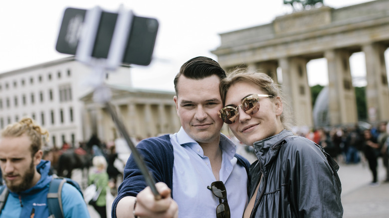 Couple uses selfie stick at Brandenburg Gate