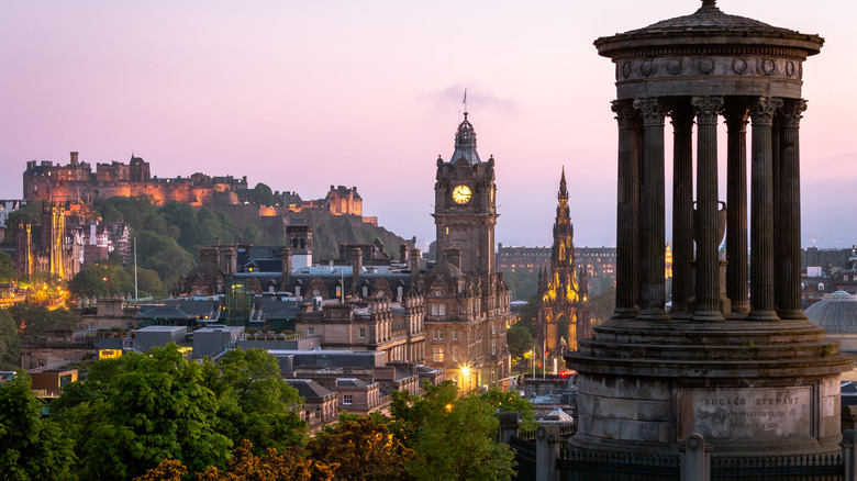 View of Edinburgh with Edinburgh Castle in the background under a pink sky