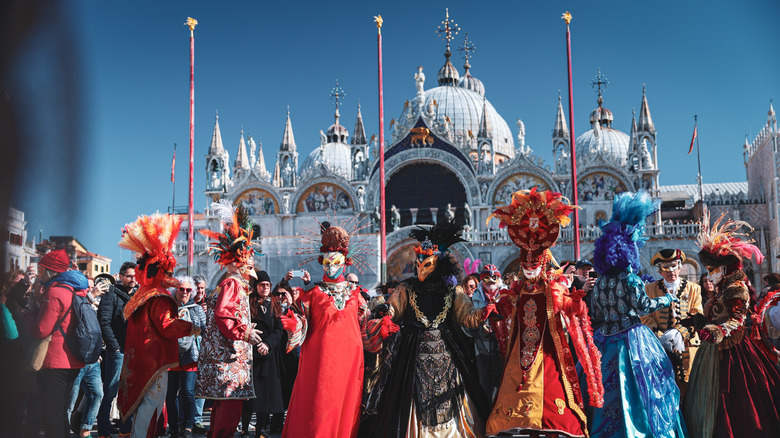 Costumed revelers at the Venice Carnival, Italy