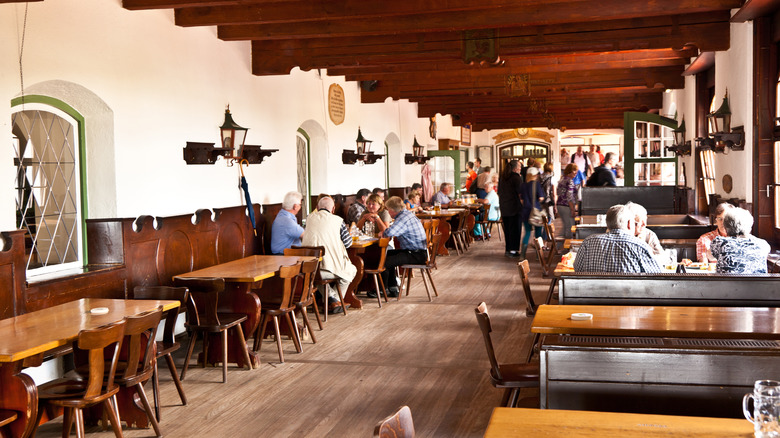 People enjoying beer in the beer hall of Andechs Monastery in Bavaria, Germany