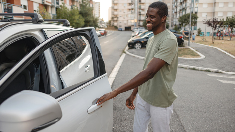 Man opening a car door