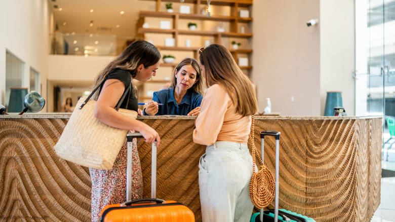 Two women with hotel reception