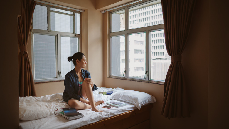 Woman in dorm by window