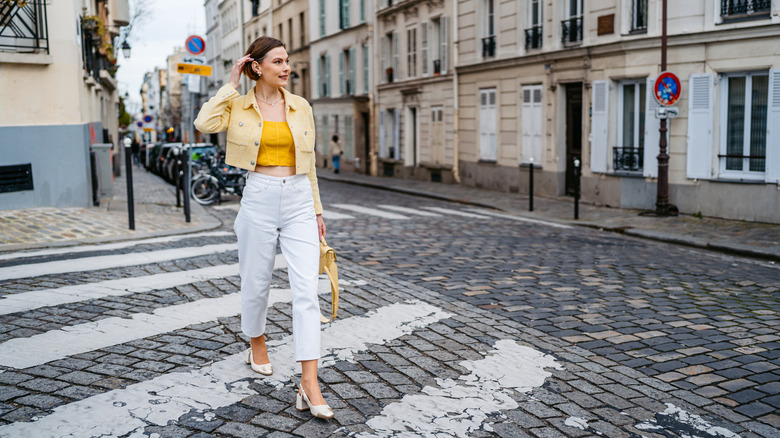 Stylish young woman crossing a street in Paris