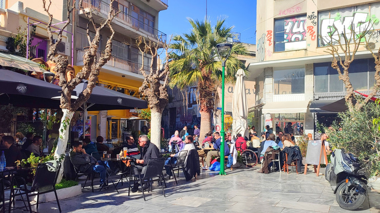 People grab a coffee at Agion café in Psyrri, Athens, Greece