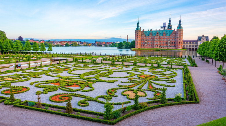Sunset view of gardens of Frederiksborg Slot palace in Denmark.