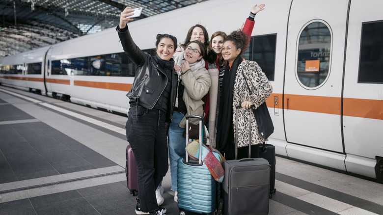 People taking selfies in a German train station