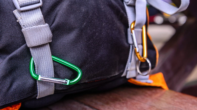 A backpack strap with carabiners on them