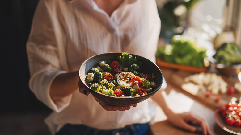 Person with a vegetarian lunch dish at a restaurant