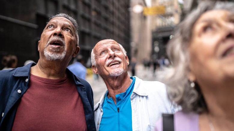 Senior travelers looking up