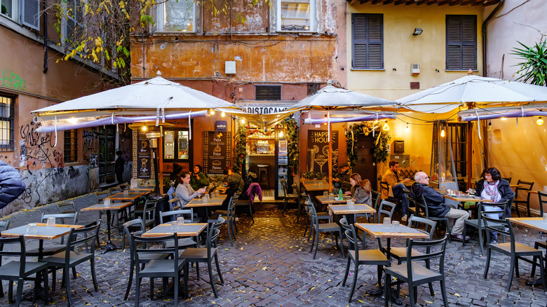 Tables and diners outside of a restaurant in Rome