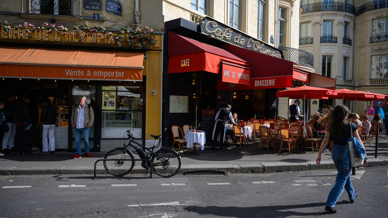 A woman walks outside a bakery in Paris