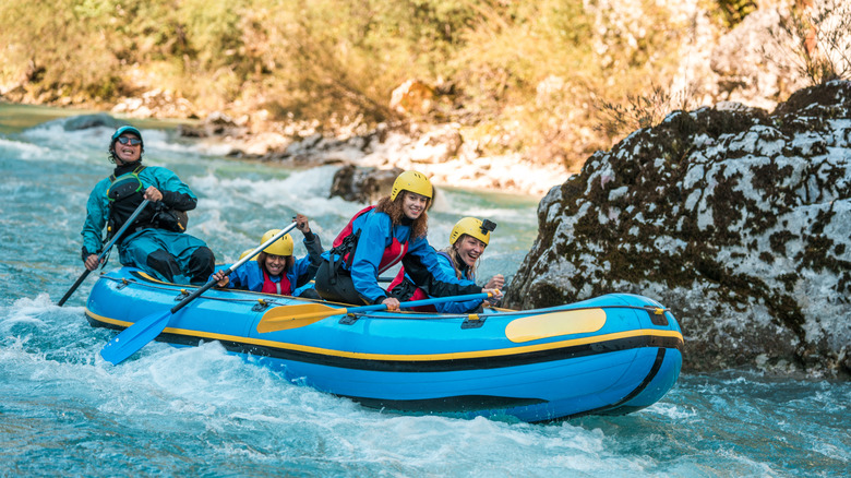 Young group of women whitewater rafting
