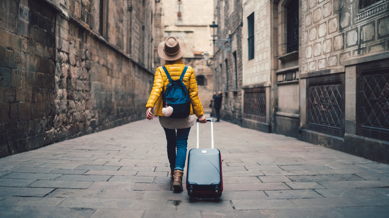 Solo female traveler rolling backpack 