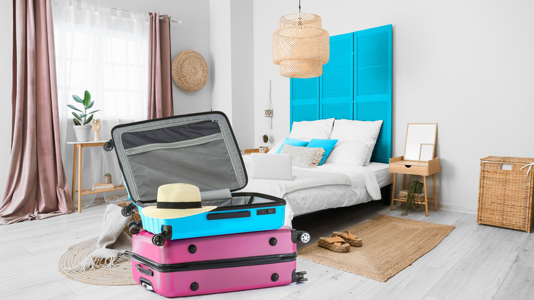 Two open suitcases on the hotel room floor