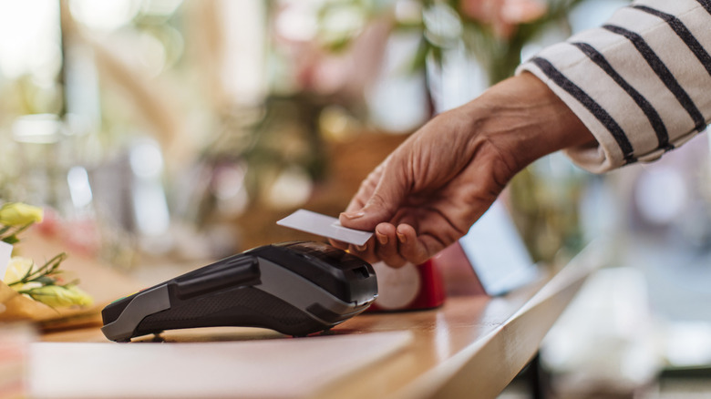 Person using a credit card at a store