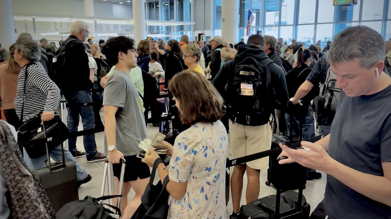Passengers arriving at JFK airport await to clear U.S. Customs