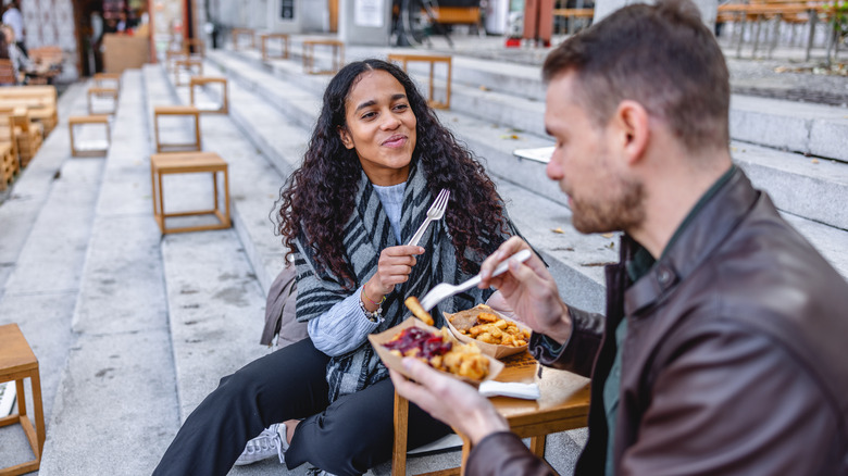 Couple eating lunch on steps