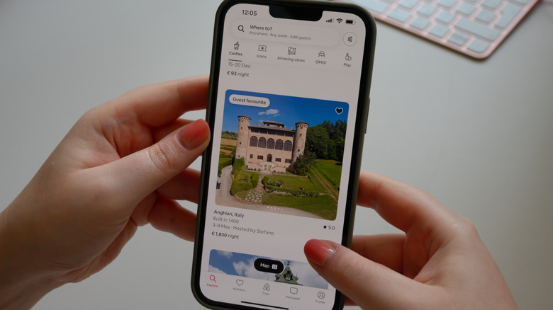 Someone looking up an Airbnb on the app on their phone