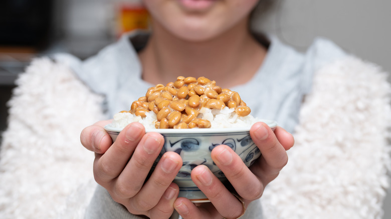 Japanese kid holding a bowl of natto gohan