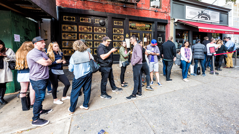 People waiting in a long line for a hot spot