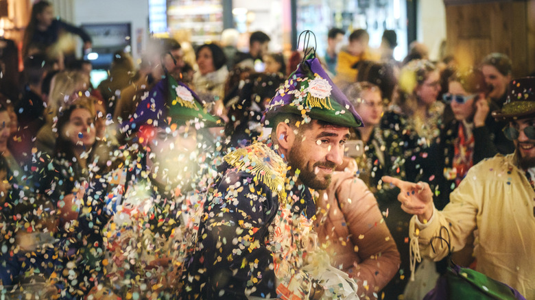 Crowds and confetti in the streets of Spain during Carnival.