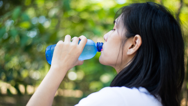 Woman drinking bottled water