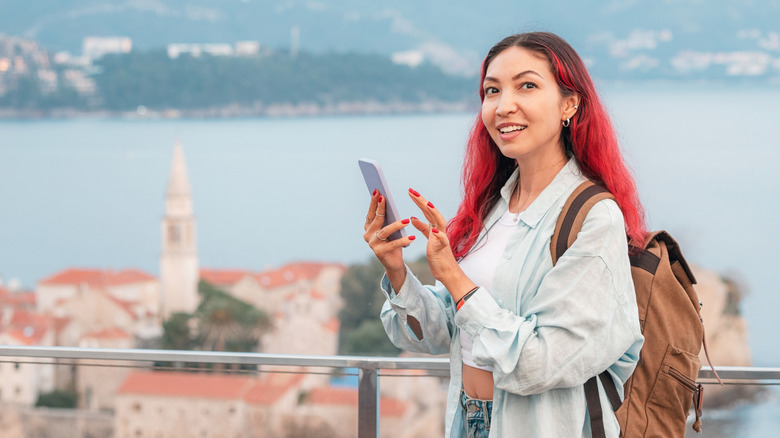 Woman uses cell phone while traveling in Europe