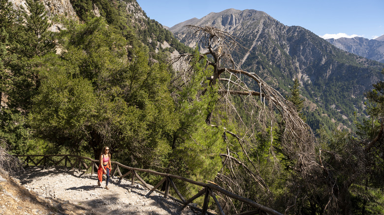 Lone hiker walking along a mountain path in Crete, Greece.