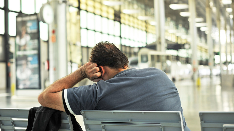 man naps train station spain