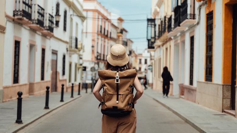 Young woman tourist wandering the streets of Europe on a trip