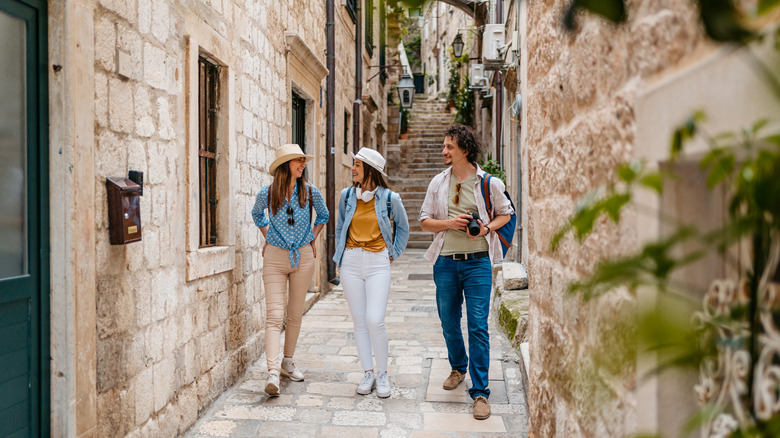 Three tourists walking down Dubrovnik's narrow streets