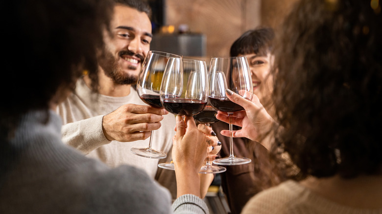 Friends toasting with glasses of red wine