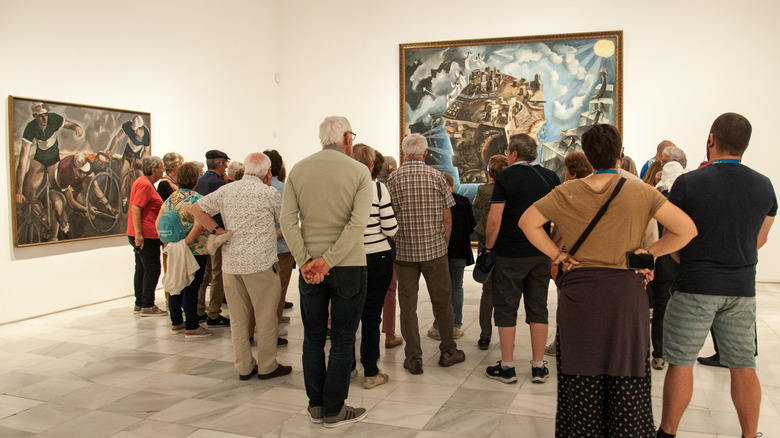 Visitors on a guided tour through an art museum
