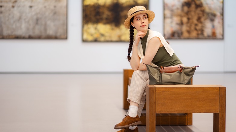 Traveler sitting on a bench in an art museum
