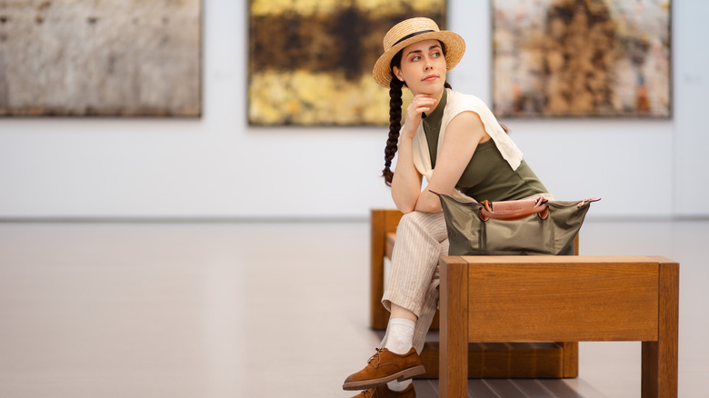 Traveler sitting on a bench in an art museum