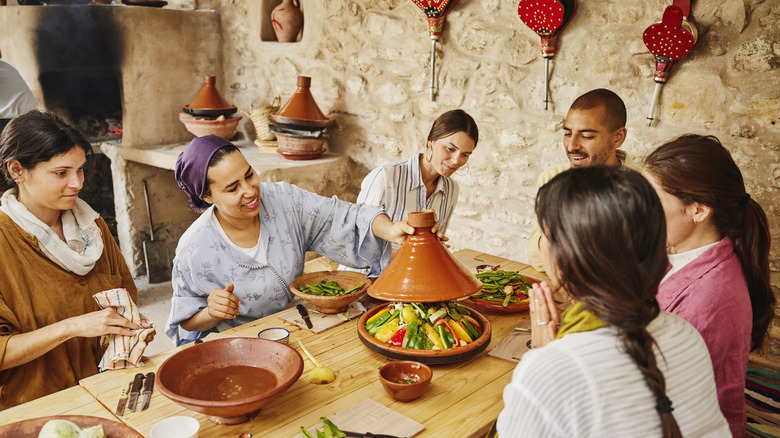 Lifting a tagine during a cooking class