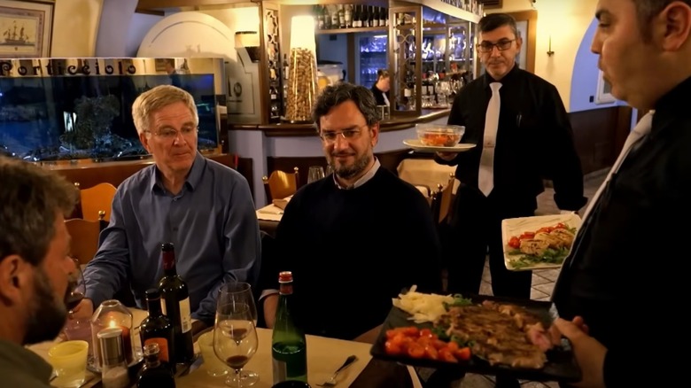 Rick Steves dining in a restaurant