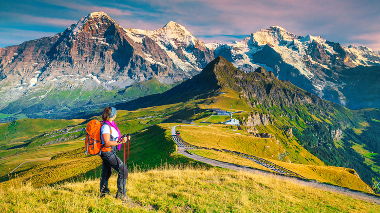 A lone female hiker in the Swiss Alps in summer