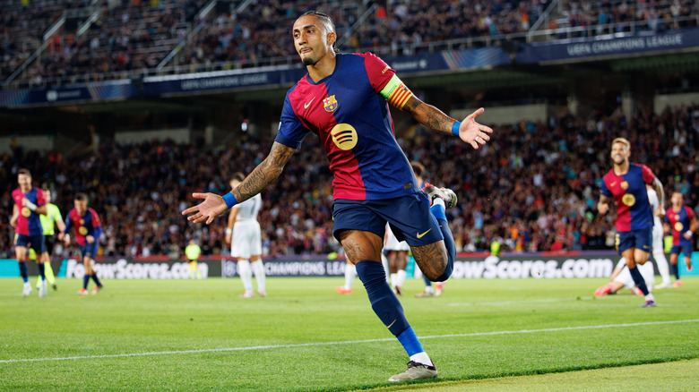 Raphinha running on a football field for FC Barcelona