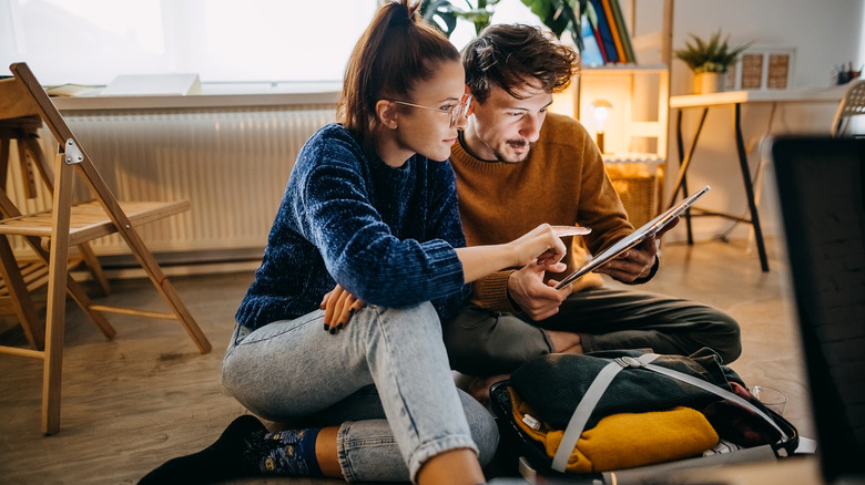 couple planning trip on tablet