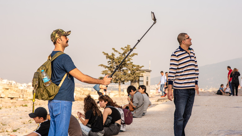Man uses selfie stick at the Acropolis