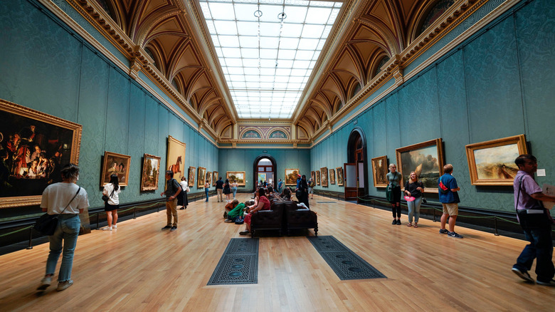 Tourists milling around artworks in London's National Gallery