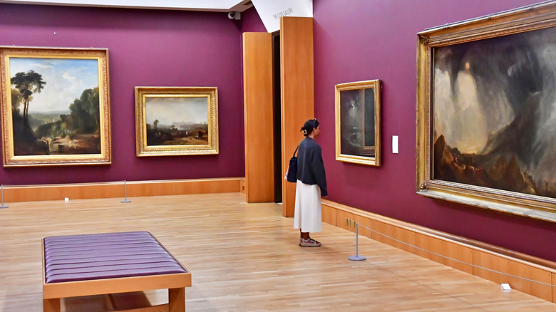 Woman standing in front of painting in Tate Britain